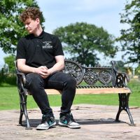 Cast Iron Aged Black Bench with Dog Motif and Male for Scale