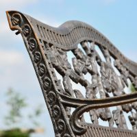 Close up of Aged Black Cast Iron "Rose" Garden Bench Backrest