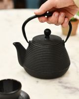 Black Teapot In Use 