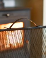 Close Up Of Black Contemporary Curved Fire Guard with Handle Close Up Of Black Contemporary Curved Fire Guard with Handle