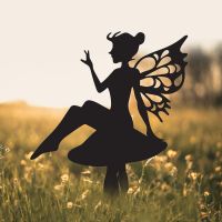 Flower Fairy Sitting on Toad Stool Silhouette in Use in a Field