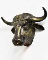 Angled view of gold animal head wall bust