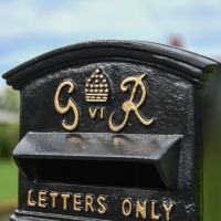 Close-Up of Gold King George Motif on Black Post Box