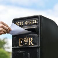 Letter Flap in Use on Freestanding Black Post Box Letter Flap in Use on Freestanding Black Post Box