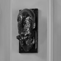 Black mouse door knocker on grey door Black mouse door knocker on grey door