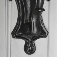 Close-Up of Detailed Pattern on Black Door Knocker Close-Up of Detailed Pattern on Black Door Knocker