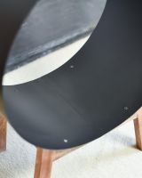 Close-Up of Black Round Steel "Barrel" Log Holder with Wooden Legs Close-Up of Black Round Steel "Barrel" Log Holder with Wooden Legs