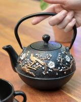 "Mejiro" Cast Iron Japanese Style Teapot - Black & Gold with Hand in Shot for Scale