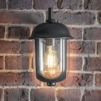 Black Traditional Wall Mounted Lantern Mounted on a Brick Wall Black Traditional Wall Mounted Lantern Mounted on a Brick Wall