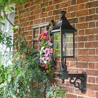Black Victorian Wall Lantern With Brass Decoration On Wall Bracket