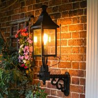 digital representation of Black Victorian Wall Light With Brass Bar Decoration 98 x 66cm lit up at night