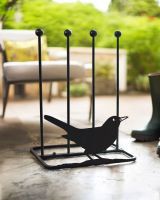Boot rack with blackbird silhouette attached to the front in the porch Boot rack with blackbird silhouette attached to the front in the porch