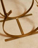 Close-Up of Emoty Blacksmith Brass Finish Curved Log Rack Close-Up of Emoty Blacksmith Brass Finish Curved Log Rack