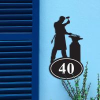 Iron Blacksmith House Number Sign in Situ on a Blue Wall 