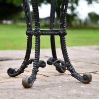 Close up of Aged Black Cast Iron Side Table