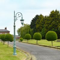 Blue Cast Iron Lamp Post In Period Garden Setting