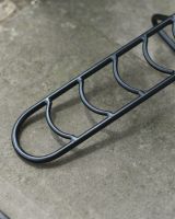 Close up of steel detailing on black boot jack