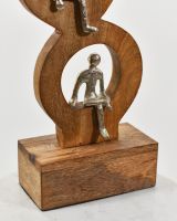 Close up of bottom cast aluminium silver figure on mango wood base