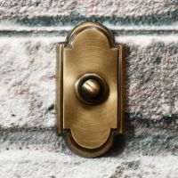 Antique Bronze Bell Push with arch on brick wall