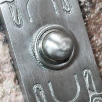 Close up of Satin Chrome door bell push button