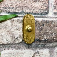 Beautiful solid brass front door bell on brick wall