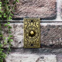 Antique brass front door bell on brick wall Antique brass front door bell on brick wall