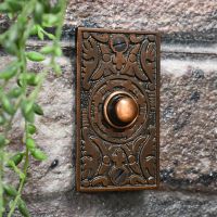 Front door bell push on brick wall