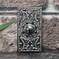 Bright chrome bell push on brick wall Bright chrome bell push on brick wall