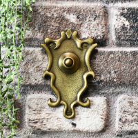 classical design ornate door bell on brick wall