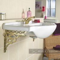 Brass Serpent Design Shelf Bracket Being Use to Hold Up a Sink