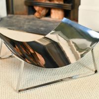 Close-up of the Top of the Bright Chrome Curved Contemporary Log Holder Close-up of the Top of the Bright Chrome Curved Contemporary Log Holder