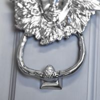 Close-Up of Door Knocker Handle on Bright Chrome Maiden Design
