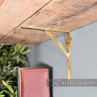 Polished Brass Gallows Bracket holding up a Shelf Polished Brass Gallows Bracket holding up a Shelf
