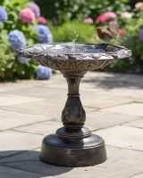 Digital illustration of Brushed Gold "Plumis" Bird Bath on sunny patio garden with robin landing on edge of filled bird bath