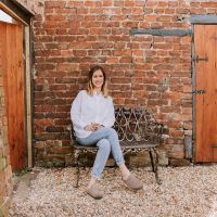 Brushed Gold "Chorley" Daisy Bench with Woman for Scale  Brushed Gold "Chorley" Daisy Bench with Woman for Scale