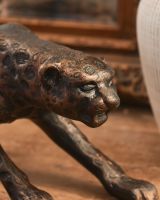 Close up of bronze leopard head Close up of bronze leopard head