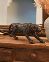 Three quarter view of bronze leopard sculpture Three quarter view of bronze leopard sculpture