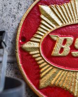Close up of "BSA" Cast Iron Automobilia Reproduction Sign finish