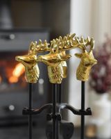 Close up of stag head detail on fireside companion set Close up of stag head detail on fireside companion set