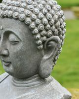 Close up of intricate detail on buddha garden statue Close up of intricate detail on buddha garden statue