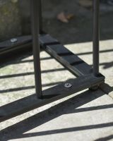 Close up of base detail on black boot rack Close up of base detail on black boot rack