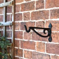 Black Scroll Iron Hanging Basket Bracket in Situ on Brick Wall