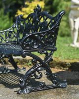 Close up of ornate detailing on leaf detail garden bench