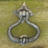 "Capulet" Pewter Shakespeare Door Knocker On A Green Door "Capulet" Pewter Shakespeare Door Knocker On A Green Door