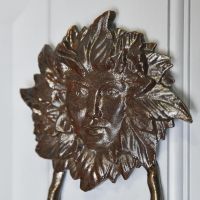 Close-Up of Black Cast Iron "Green Women" Door Knocker