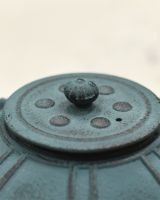 Close up of Teal Cast Iron Lid on Teapot