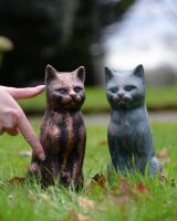 ‘Zen’ the Cast Aluminium Sitting Cat Garden Sculpture - Copper stood with verdigris version and hand in shot to reference scale