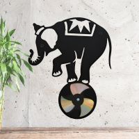 CD Elephant On Ball Next To Plant