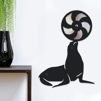 CD Seal With Ball On White Background Next To Plant