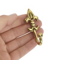 Curtain tie back hook polished brass in hand Curtain tie back hook polished brass in hand